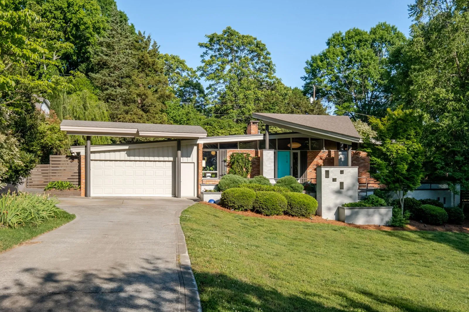 Aerial over 714 Larkhall Ln showing the mid-century roofline and 3/4-acre lot