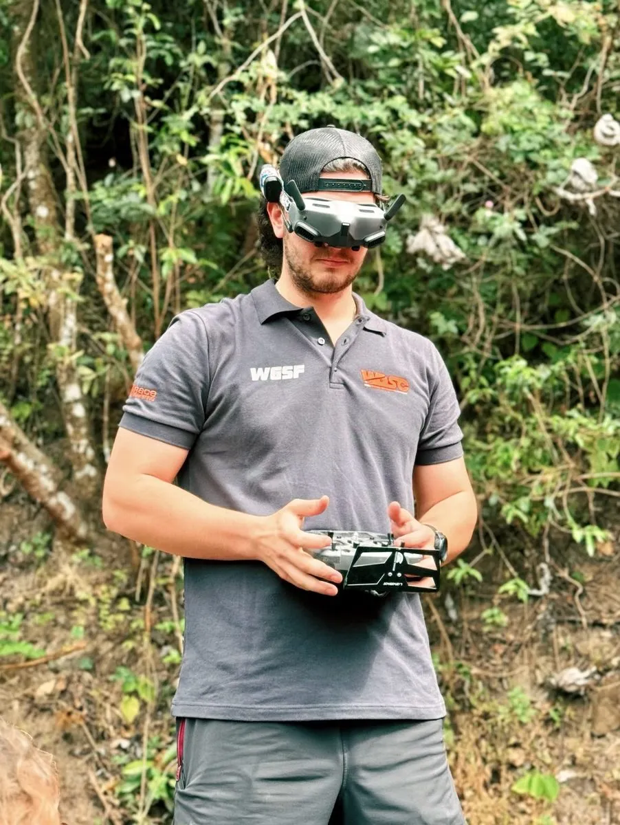 Hunter Sowers on an FPV shoot, goggles on, radio in hand